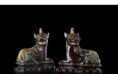 A pair of sancai glaze Buddhist lions, on wood bases (restorations) China, 18th century (l. 19.5 cm.)