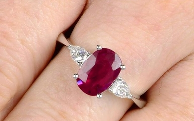 A ruby and pear-shape diamond three-stone ring. Ruby