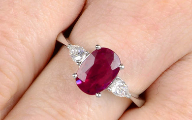 A ruby and pear-shape diamond three-stone ring.