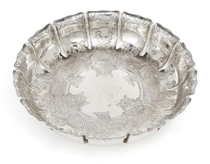 A silver strawberry dish, London, 1928, Manoah Rhodes & Sons, the fluted sides and base chased with foliate scroll decoration, 21.5cm dia., 4.9cm high, approx. weight 17.1oz