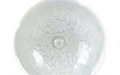 A small Chinese shallow celadon dish of flowerhead form decorated...
