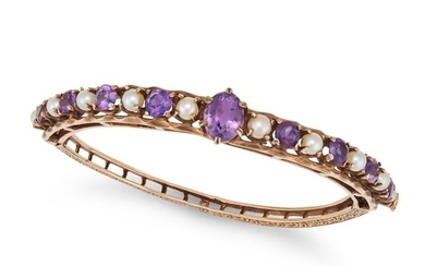 AN ANTIQUE AMETHYST AND PEARL BANGLE in 9ct yellow gold, the hinged bangle set with an oval cut