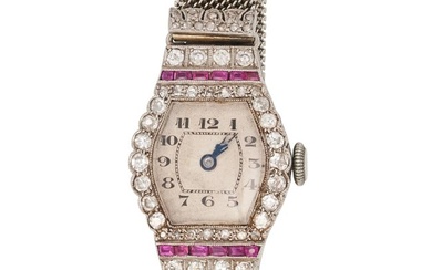AN ART DECO RUBY AND DIAMOND COCKTAIL WATCH in platinum, the off-white tonneau dial with guilloche