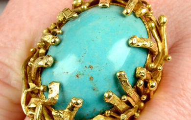 An 18ct gold turquoise dress ring, with textured bead and strand surround.