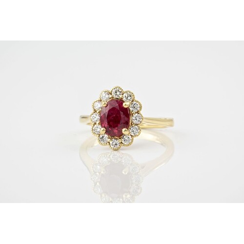 An 18ct yellow gold, ruby and diamond cluster ring, featurin...