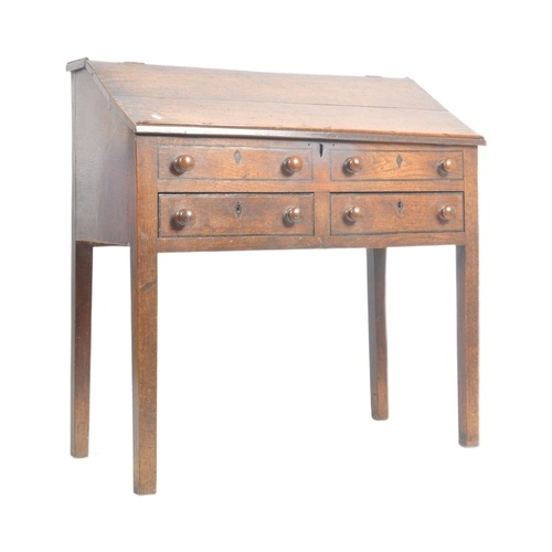 An 18th century oak and elm wood clerks desk - bureau. Raise...