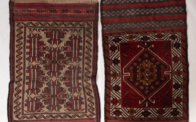 An Afghan Belouch rug, the shaded field with twin wine lozen...