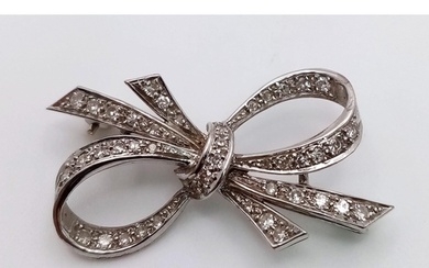 An Art Deco Style Platinum and Diamond Brooch. 1.2ctw of enc...