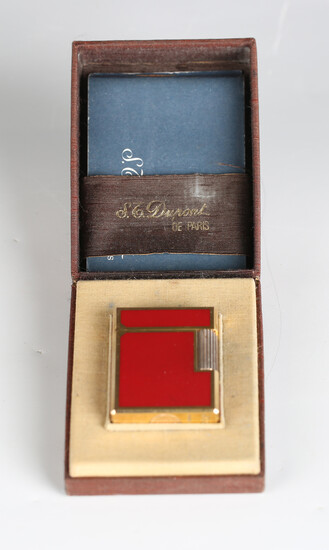 An S.T. Dupont Paris gilt metal and red enamel pocket lighter, detailed 'B5AG53', length 4