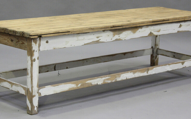 An early 20th century pine low table, on a painted base, height 58cm, length 200cm, depth 64cm.