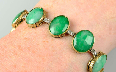 An early 20th century platinum and 14ct gold slightly graduated A-Type jade cabochon bracelet, with single-cut diamond bar spacers.