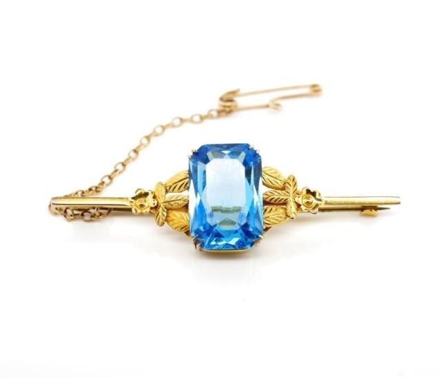 Arts & crafts yellow gold and blue glass brooch marked 9ct. ...