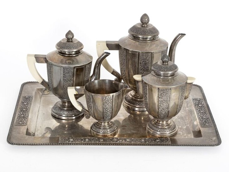 Coffee and tea set in partially embossed and carved silver...