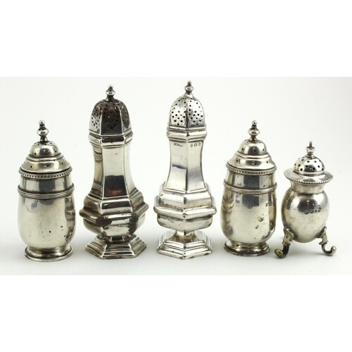 Five silver peppers, various British hallmarks. Total weight...