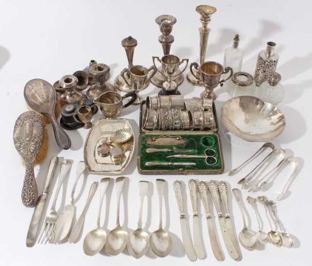 Group of Georgian and later silver to include flatware, miniature trophies, candlesticks, silver mounted sauce bottle, napkin rings and other silver and white metal items, (various dates and makers)