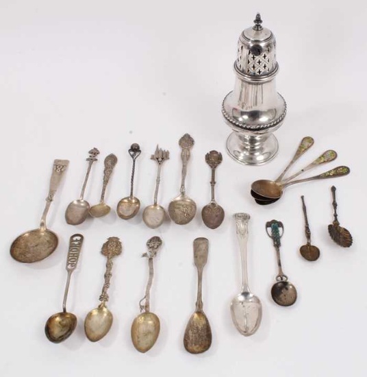 Group of silver and white metal spoons and a silver sugar sifter
