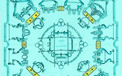 Hermès: A silk scarf with motive “Mors et Gourmettes” in blue and yellow colors.
