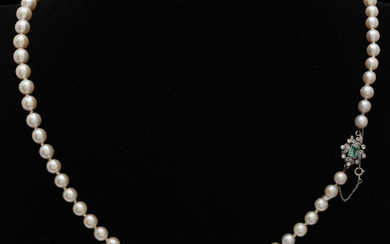 Pearls necklace with diamonds and emerald clasp, mid 20th Century.