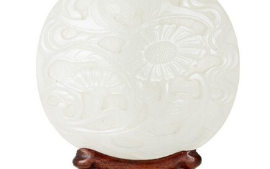 Property of a Gentleman (lots 36-85) A Chinese white jade oval 'bat and chrysanthemum' plaque, 18th century, finely carved with a bat in flight above two flowering chrysanthemum stems, 7.5x7cm, on carved wood stand