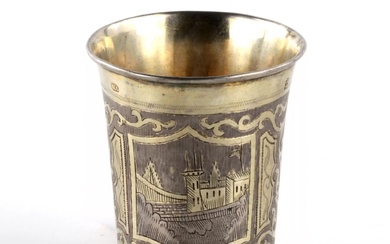 Russian silver vodka cup with city views.