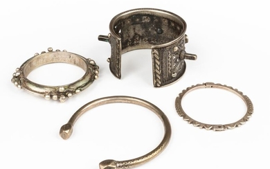 Set of four silver bracelets, one of which...