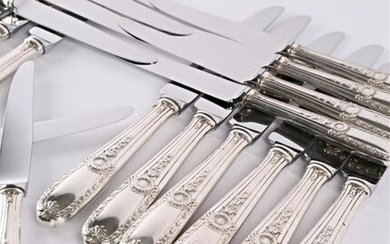 Set of twelve table knives and twelve dessert knives, silver handles decorated with fillets, laurel branches, asparagus tips and palmettes, stainless steel blades