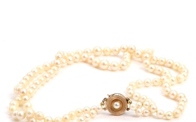 Hugo Grün: A two-strand pearl necklace set with numerous cultured pearls, with a 14k gold clasp. Clasp diam. 16 mm. L. 43.5–46 cm. Largest pearl app. 8 mm.