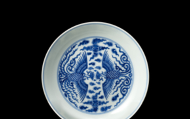 A blue and white dish decorated to the centre with a pair of phoenix in archaic style, the base with...