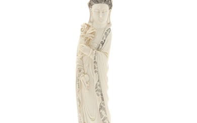 A Chinese ivory figure of an Immortal, a woman with vase and palm branch in hands. First half of 20th century. H. 37 cm.