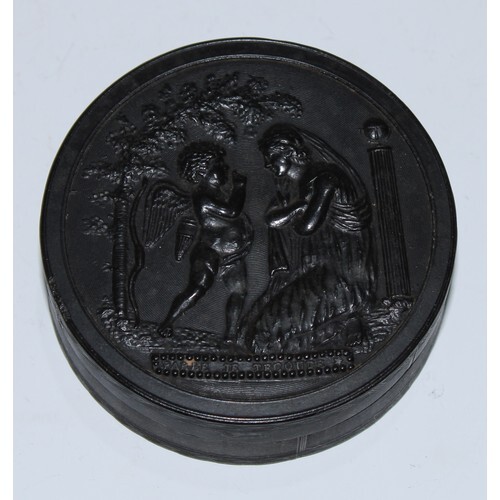 A 19th century pressed horn circular snuff box, the push-fit...