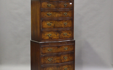 A 20th century reproduction walnut serpentine fronted chest-on-chest, fitted with two short and six