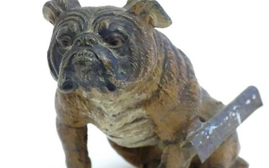A 20thC cold painted cast model of a seated bulldog.