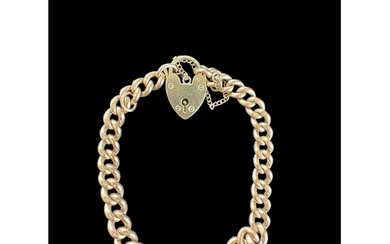 A 9ct gold graduated curblink bracelet with 9ct gold heart p...