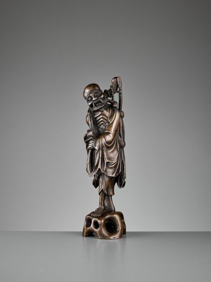A BRONZE FIGURE OF AN EMACIATED IMMORTAL, 17TH...
