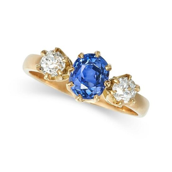 A CEYLON NO HEAT SAPPHIRE AND DIAMOND THREE STONE RING in yellow gold, set with an oval cut sapphire