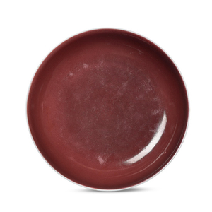 A COPPER-RED-GLAZED DISH, QIANLONG SIX-CHARACTER SEAL MARK IN UNDERGLAZE BLUE AND OF THE PERIOD (1736-1795)