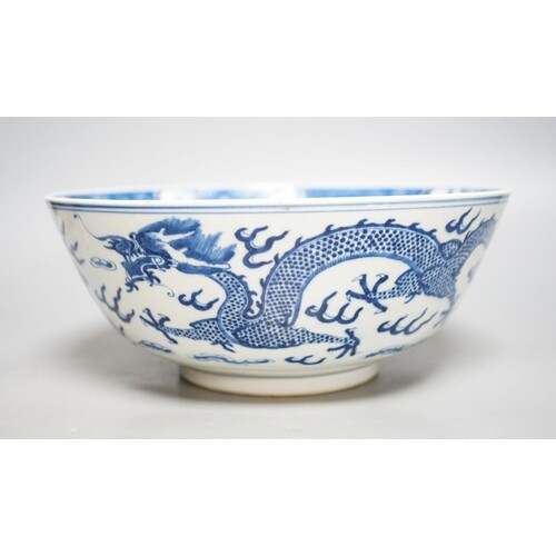A Chinese blue and white dragon bowl, Kangxi mark, late 19...