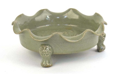 A Chinese celadon dish of scalloped circular form, relief decorated...