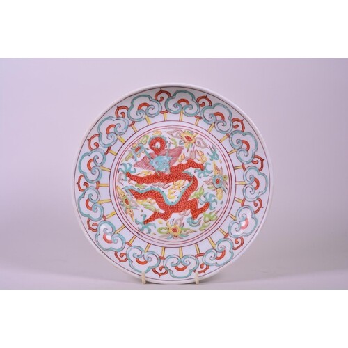 A Chinese polychrome porcelain dish decorated with a dragon ...