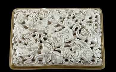 A Chinese porcelain belt buckle, panel moulded and pierced with...