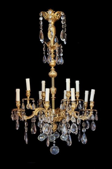 A French gilt bronze and cut glass mounted twelve light chandelier loosely in Directoire taste