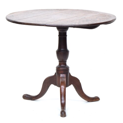 A George III oak tip-top tripod table, baluster turned colum...