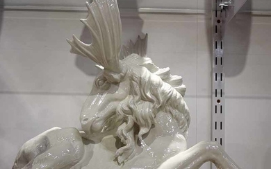 A LARGE PORCELAIN SCULPTURE OF A RECLINING MOOSE