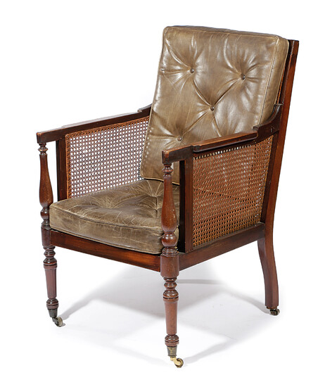 A MAHOGANY BERGERE ARMCHAIR IN REGENCY STYLE