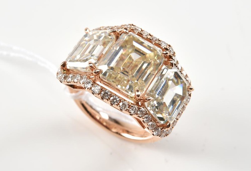 A MOISSANITE AND DIAMOND DRESS RING IN 18CT ROSE GOLD. APPROXIMATE TOTAL MOISSONITE WEIGHT 11.18CTS, APPROXIMATE TOTAL DIAMOND WEIGH...