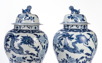 A PAIR OF BLUE AND WHITE COVERED TEMPLE JARS