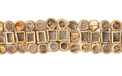 A Roman glass inlaid gold bracelet, formed of connecting elements of squares and roundels, inlaid with coloured glass, 14cm. x 2.6cm. high Provenance: Private collection UK since 1963