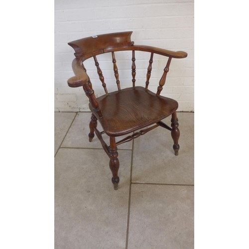 A Victorian ash and elm smokers bow armchair