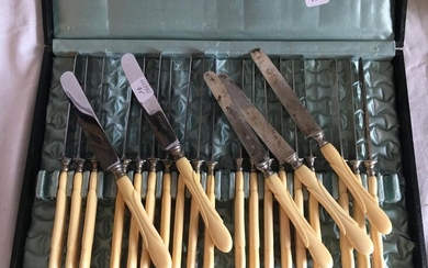 A box containing twelve cheese knives, stainless steel...