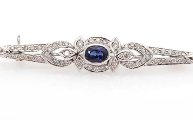 SOLD. A brooch set with a sapphire encircled by numerous diamonds weighing a total of app. 0.68 ct., mounted in 18k white gold. L. app. 5.7 cm. – Bruun Rasmussen Auctioneers of Fine Art